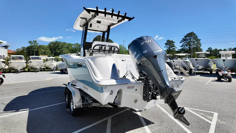 Slide: The Image of 2025 Sea Fox 248 Commander boat with outboard motor in a parking lot. - 3
