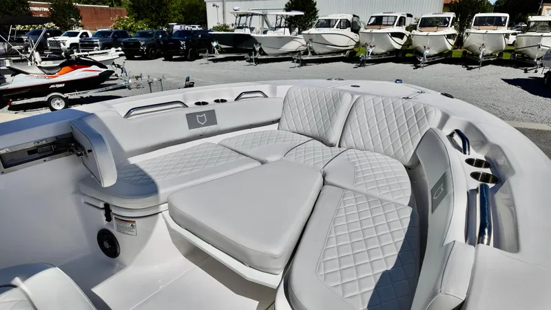 Slide: The Image of 2025 Sea Fox 248 Commander boat with spacious, cushioned seating in a showroom. - 7