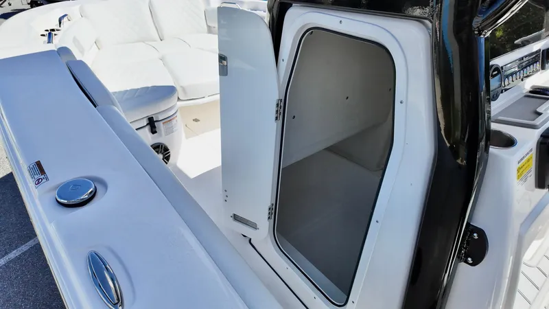 Slide: The Image of 2025 Sea Fox 248 Commander boat storage compartment with open door. - 9