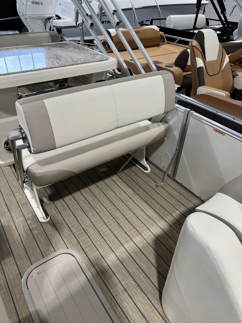 Slide: The Image of 2025 Avalon 2585 25 Catalina ENT boat interior with beige seating and wood-style flooring. - 10
