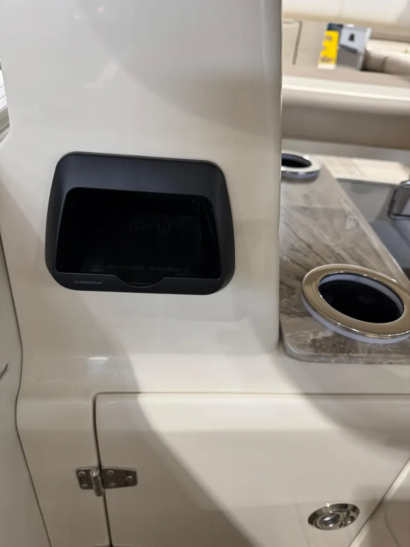 Slide: The Image of 2025 Avalon 2585 25 Catalina ENT interior with cup holders and storage compartment. - 13