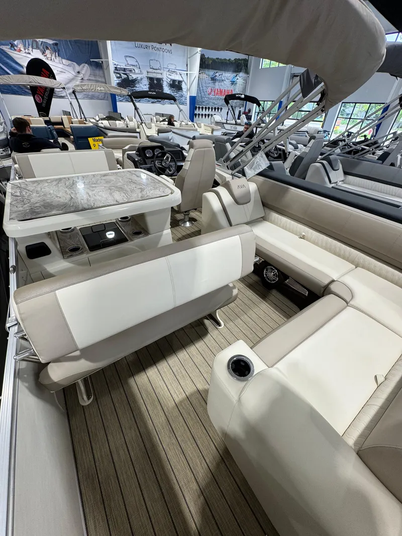 Slide: The Image of 2025 Avalon 2585 25 Catalina ENT boat interior with beige seating and wood flooring. - 14