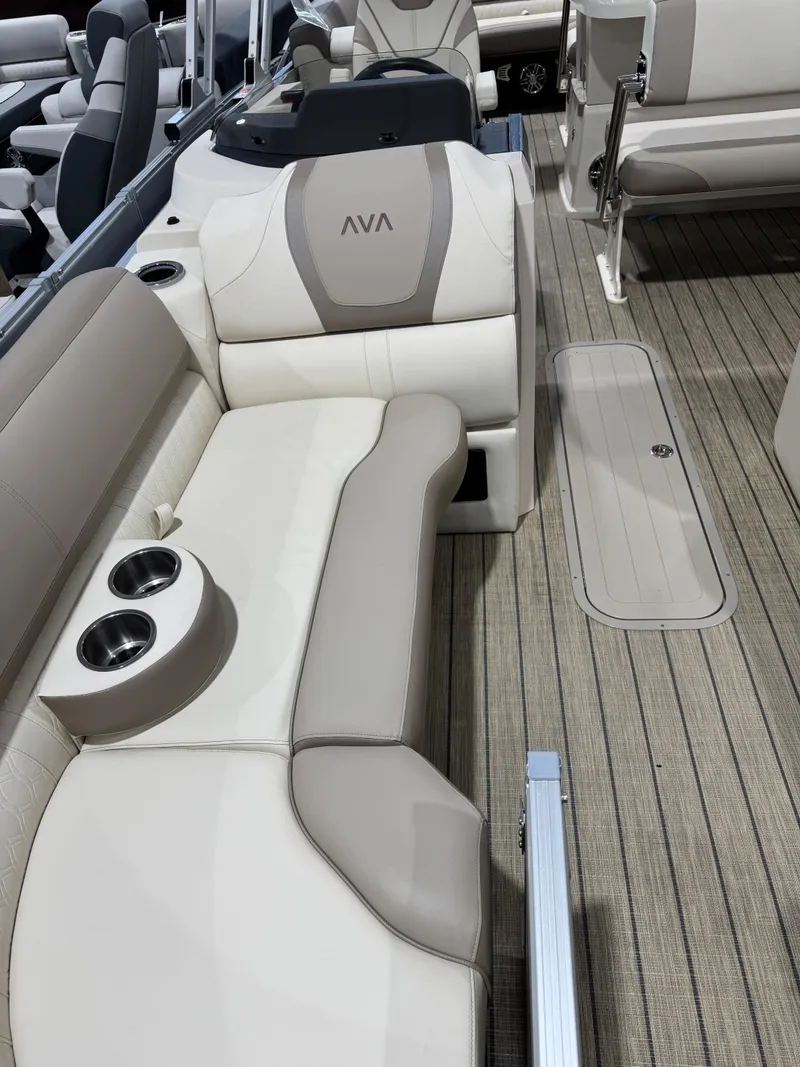 Slide: The Image of 2025 Avalon 2585 25 Catalina ENT boat interior with beige seating and cup holders. - 5