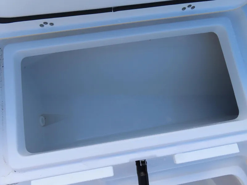 Slide: The Image of Open storage compartment in 2023 Sportsman Heritage 231 Center Console boat. - 11