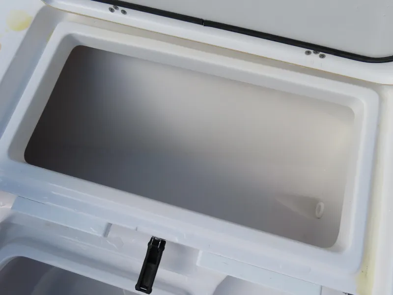 Slide: The Image of Open storage compartment on 2023 Sportsman Heritage 231 Center Console boat. - 13