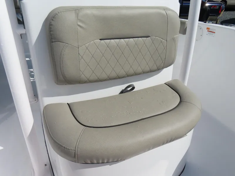 Slide: The Image of 2023 Sportsman Heritage 231 Center Console boat seat with beige upholstery and diamond stitching. - 16