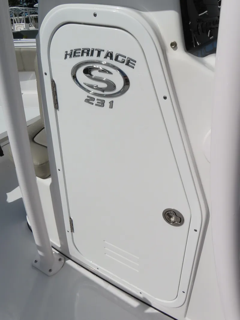 Slide: The Image of 2023 Sportsman Heritage 231 Center Console boat door with logo and sleek design. - 18