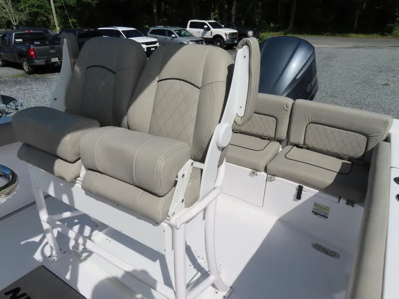 Slide: The Image of 2023 Sportsman Heritage 231 Center Console boat with beige seating and console. - 20