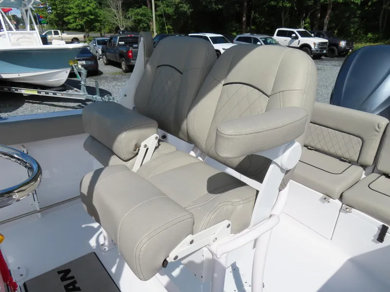 Slide: The Image of 2023 Sportsman Heritage 231 Center Console boat with beige cushioned seating. - 22