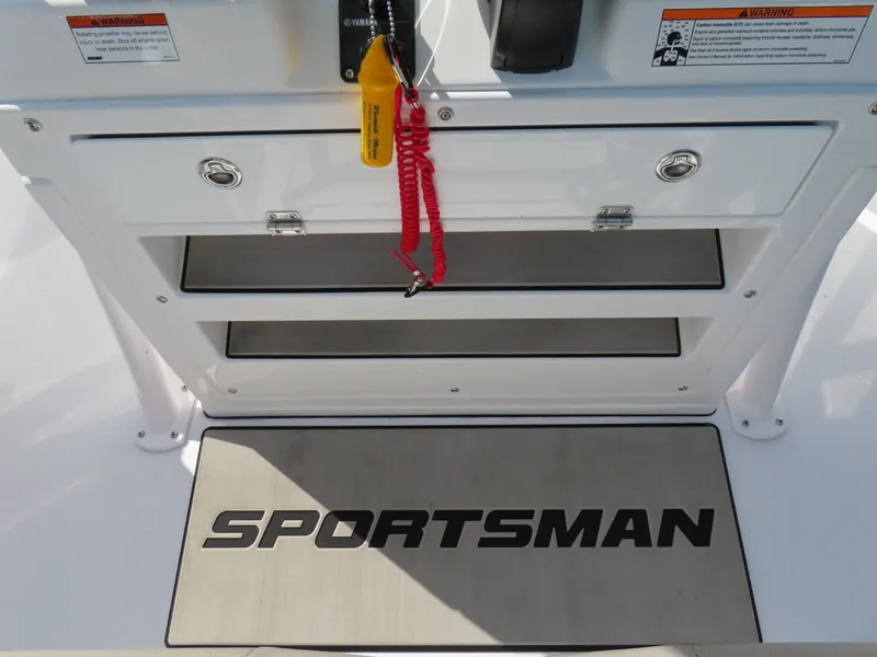 Slide: The Image of 2023 Sportsman Heritage 231 Center Console dashboard with storage compartments and branded mat. - 26