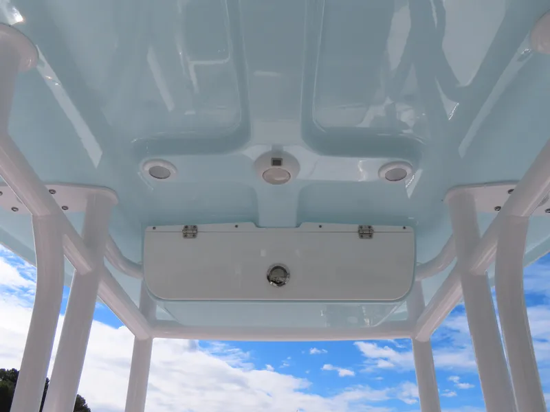 Slide: The Image of 2023 Sportsman Heritage 231 Center Console T-top against a blue sky. - 27