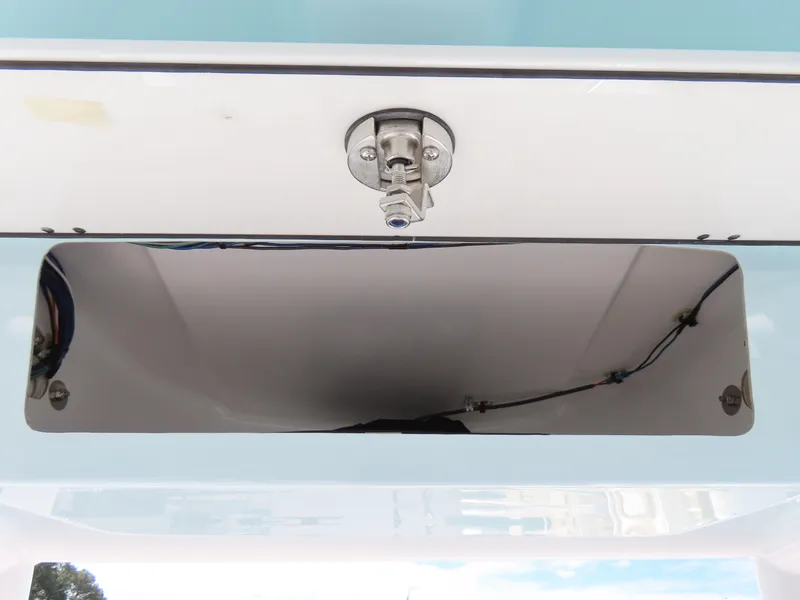 Slide: The Image of 2023 Sportsman Heritage 231 Center Console storage compartment with latch, showcasing sleek design. - 28