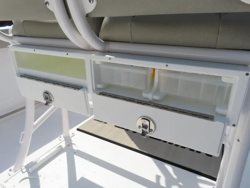 Slide: The Image of 2023 Sportsman Heritage 231 Center Console storage compartments with secure latches and cushioned seating. - 31