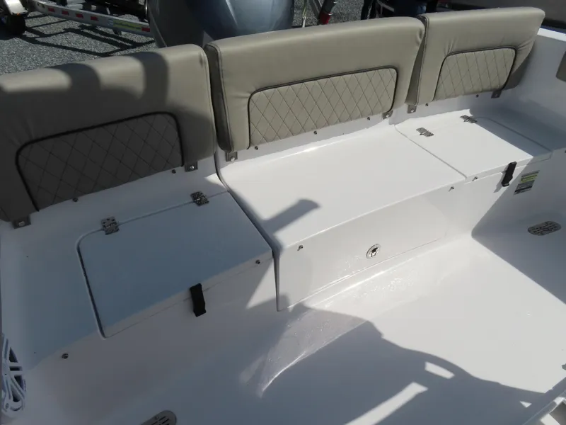 Slide: The Image of 2023 Sportsman Heritage 231 Center Console boat seating with storage compartments. - 33