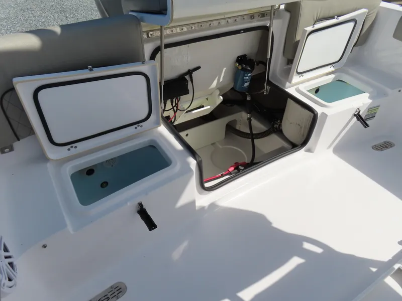 Slide: The Image of 2023 Sportsman Heritage 231 Center Console boat interior with open storage compartments. - 34