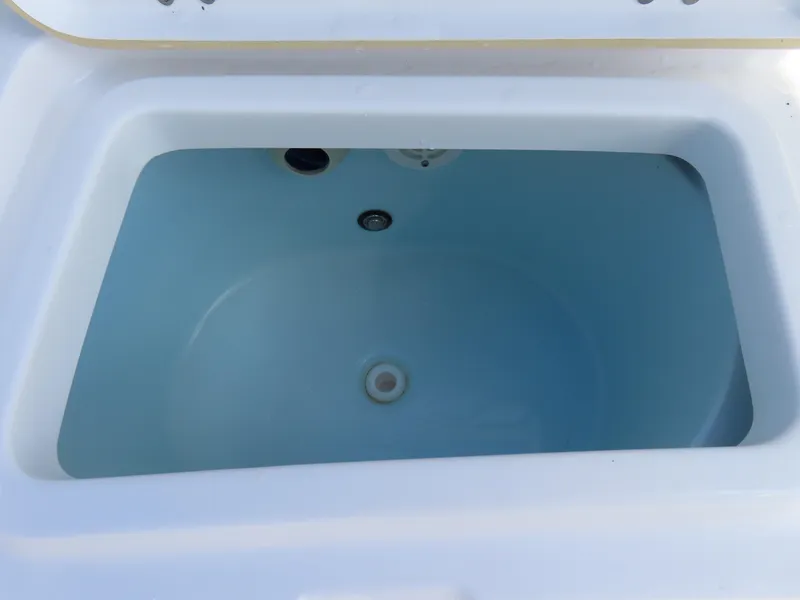 Slide: The Image of 2023 Sportsman Heritage 231 Center Console livewell, white interior, rectangular shape. - 35