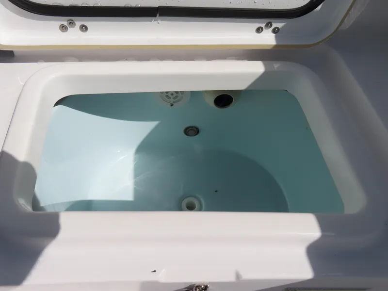 Slide: The Image of Livewell on 2023 Sportsman Heritage 231 Center Console boat, open lid, filled with water. - 37