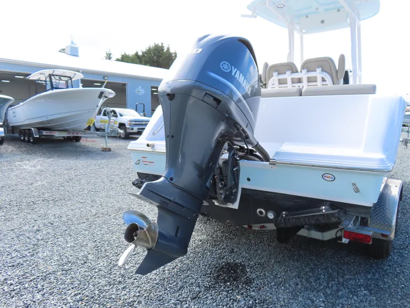 Slide: The Image of 2023 Sportsman Heritage 231 Center Console with Yamaha outboard motor, parked on gravel. - 5