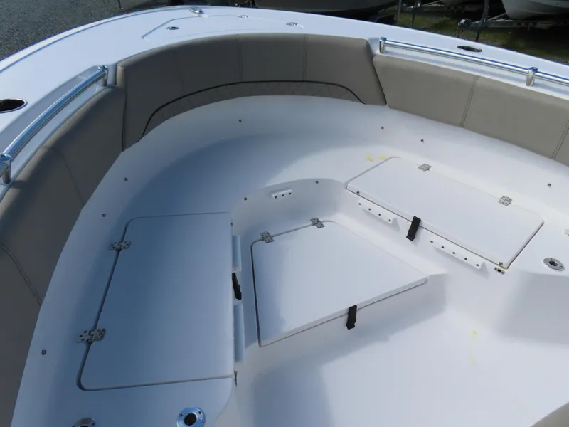 Slide: The Image of 2023 Sportsman Heritage 231 Center Console boat interior with cushioned seating and storage compartments. - 9