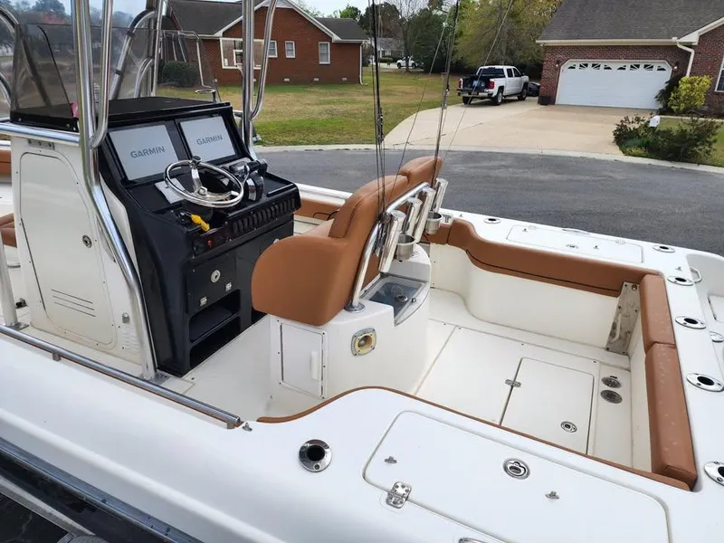 Slide: The Image of 2010 Blackwood 270 boat interior with dual Garmin displays and tan seating. - 10