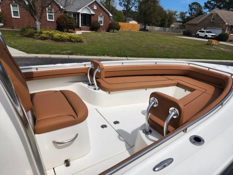 Slide: The Image of 2010 Blackwood 270 boat with tan seating, parked in a suburban neighborhood. - 11