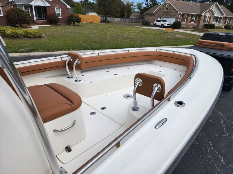 Slide: The Image of 2010 Blackwood 270 boat with tan seating, parked in a suburban neighborhood. - 12
