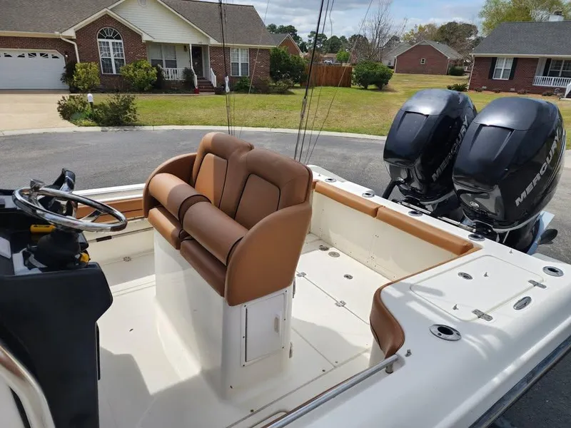 Slide: The Image of 2010 Blackwood 270 boat with dual Mercury engines, brown seating, and steering wheel in a residential area. - 13