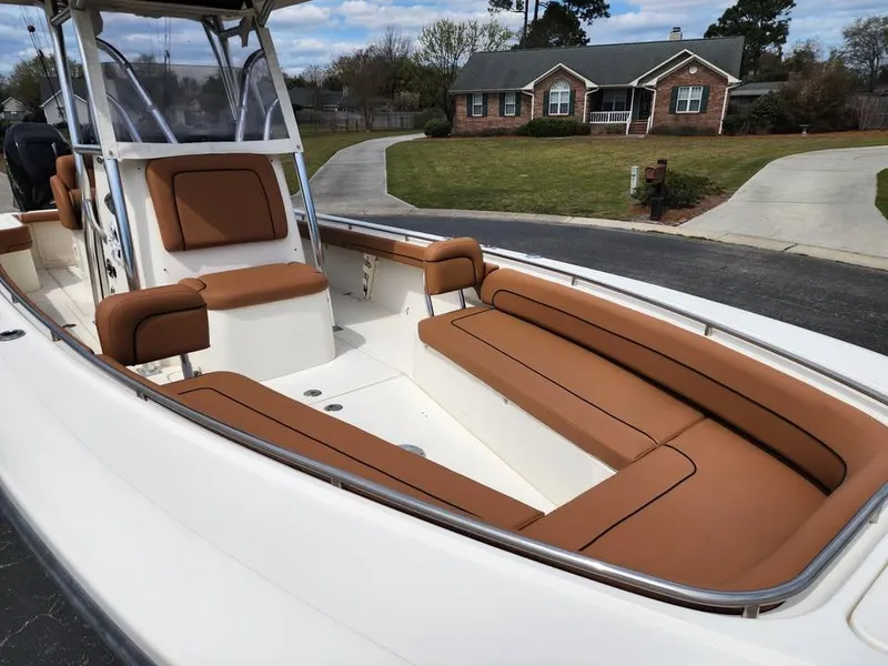 Slide: The Image of 2010 Blackwood 270 boat with tan seating, parked in a residential driveway. - 19