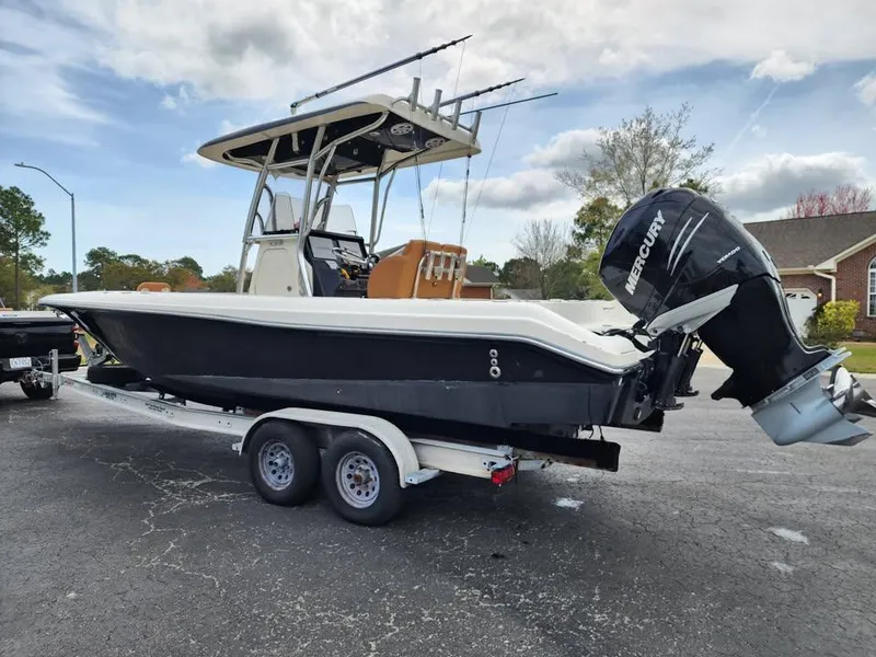 Slide: The Image of 2010 Blackwood 270 boat on trailer with Mercury outboard motor, parked outdoors. - 4