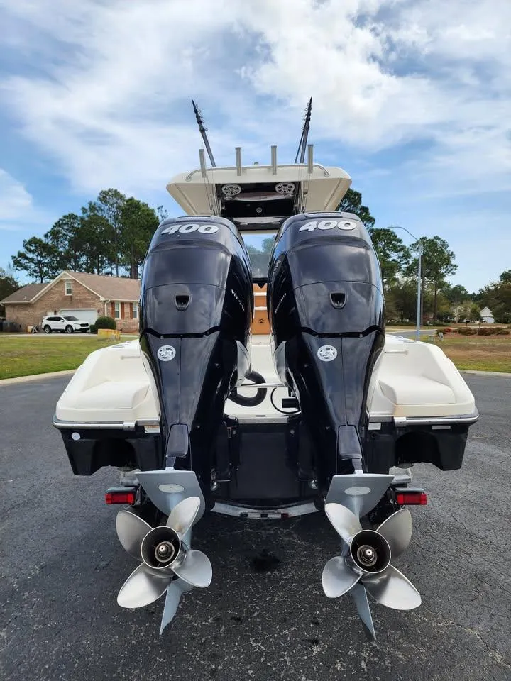 Slide: The Image of 2010 Blackwood 270 boat with dual 400 horsepower engines, parked outdoors. - 5