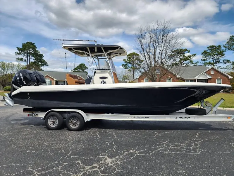 Slide: The Image of 2010 Blackwood 270 boat on trailer, parked outdoors under cloudy sky. - 6