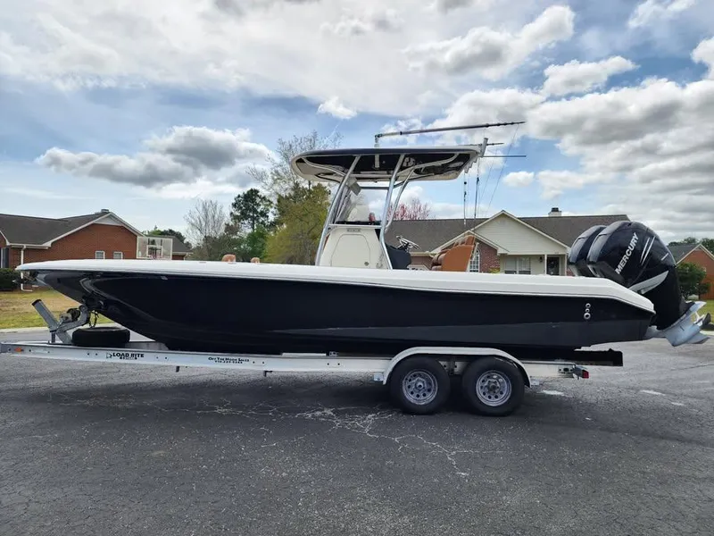 Slide: The Image of 2010 Blackwood 270 boat on trailer, parked outdoors under cloudy sky. - 7