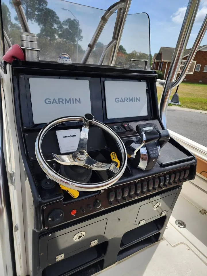 Slide: The Image of Control panel of a 2010 Blackwood 270 boat with Garmin navigation displays. - 8