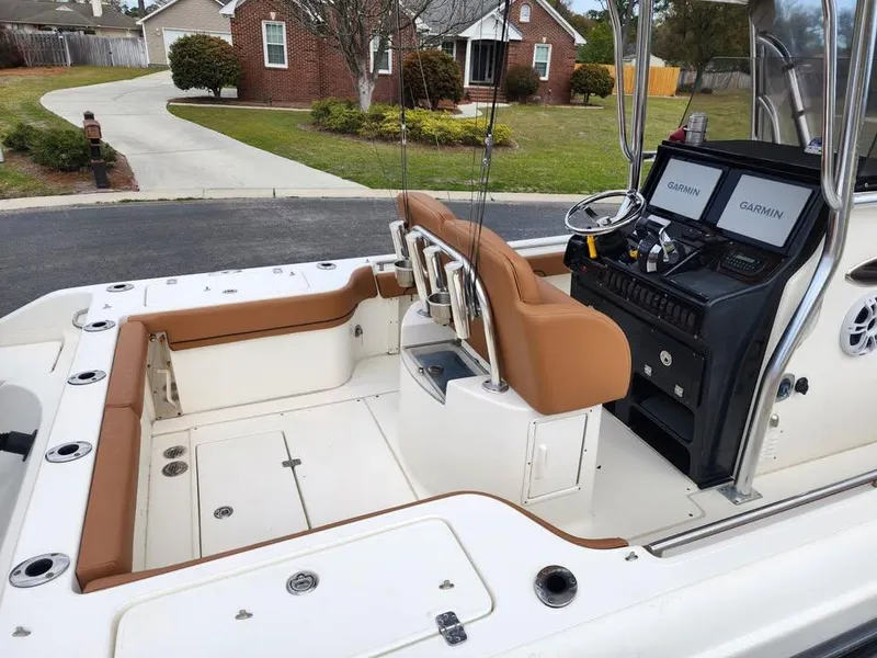 Slide: The Image of 2010 Blackwood 270 boat interior with tan seating and Garmin navigation system. - 9