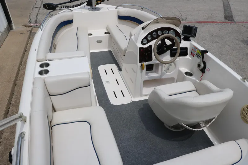Slide: The Image of 2006 Hurricane GS 172 boat interior with white seating and steering console. - 12