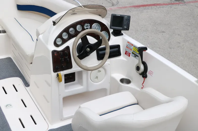 Slide: The Image of 2006 Hurricane GS 172 boat cockpit with steering wheel and control panel. - 13