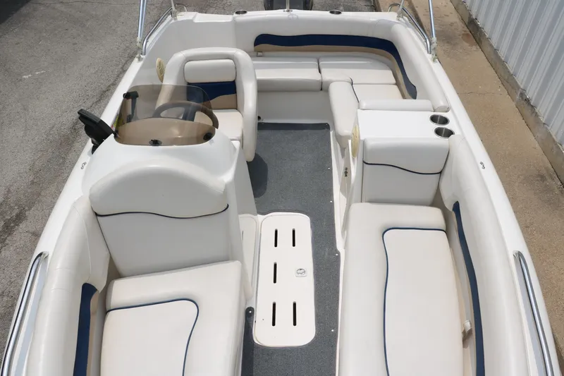 Slide: The Image of 2006 Hurricane GS 172 boat interior with white seating and steering console. - 16
