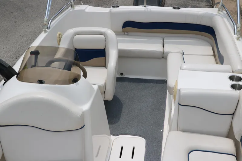 Slide: The Image of 2006 Hurricane GS 172 boat interior with white and blue seating, steering console, and cup holders. - 17