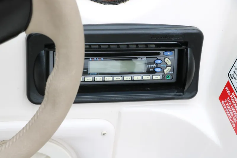 Slide: The Image of 2006 Hurricane GS 172 boat dashboard with stereo system and steering wheel. - 22