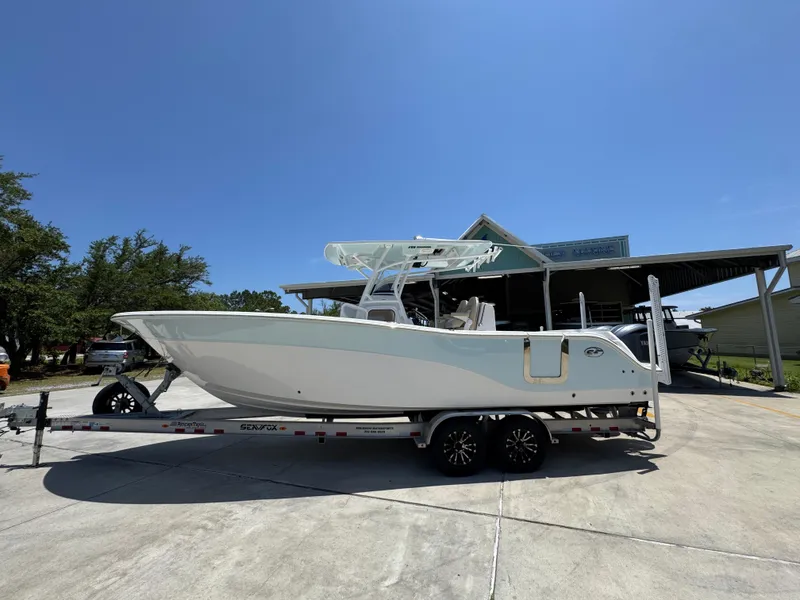 Slide: The Image of 2022 Sea Fox 288 Commander boat on trailer under clear blue sky. - 1