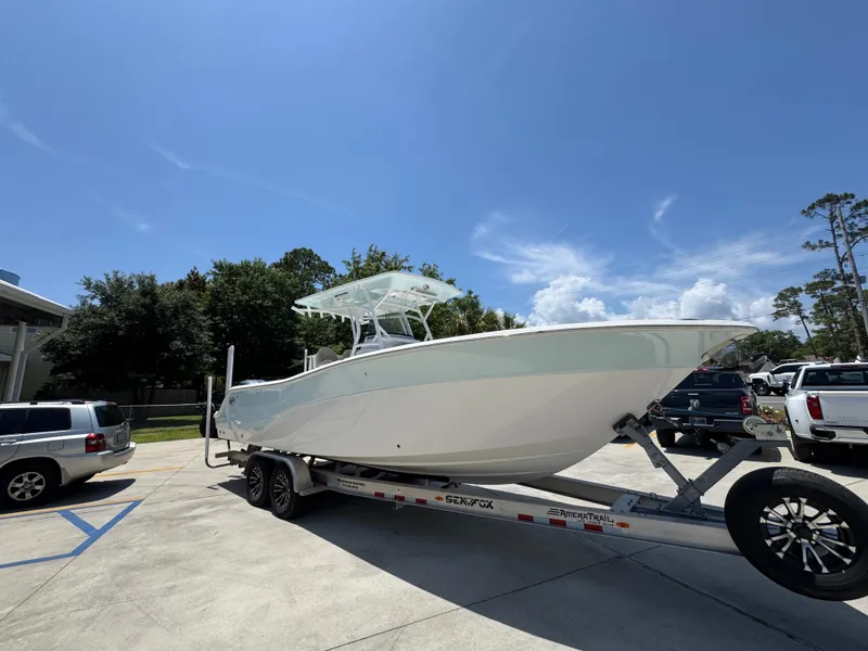 Slide: The Image of 2022 Sea Fox 288 Commander boat on trailer under clear blue sky. - 10