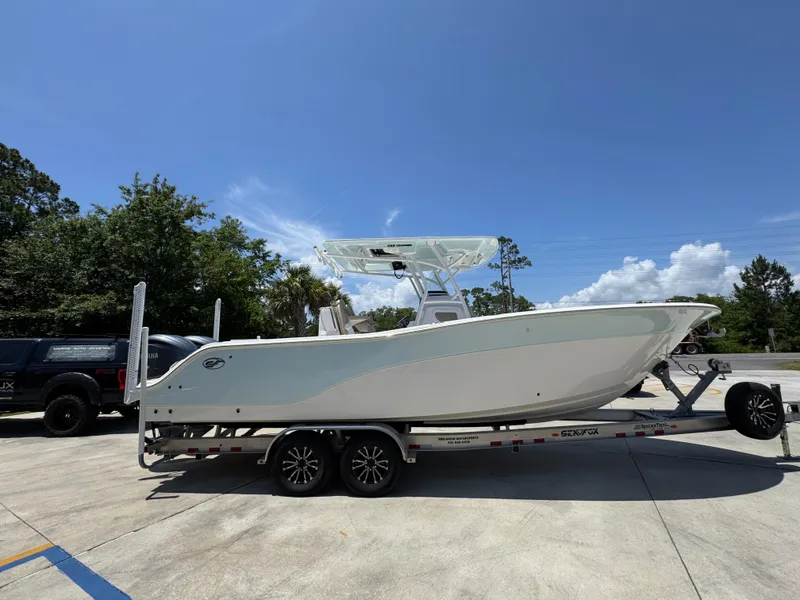 Slide: The Image of 2022 Sea Fox 288 Commander boat on trailer under clear blue sky. - 12