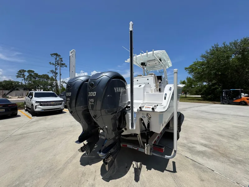 Slide: The Image of 2022 Sea Fox 288 Commander boat with dual Yamaha 300 engines, parked outdoors. - 16