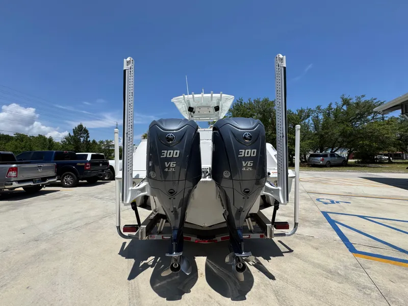 Slide: The Image of 2022 Sea Fox 288 Commander with twin 300 V6 engines, parked outdoors. - 18