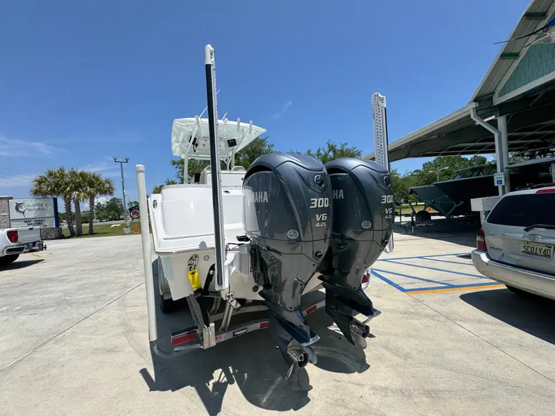 Slide: The Image of 2022 Sea Fox 288 Commander with dual Yamaha 300 engines in a sunny marina setting. - 19