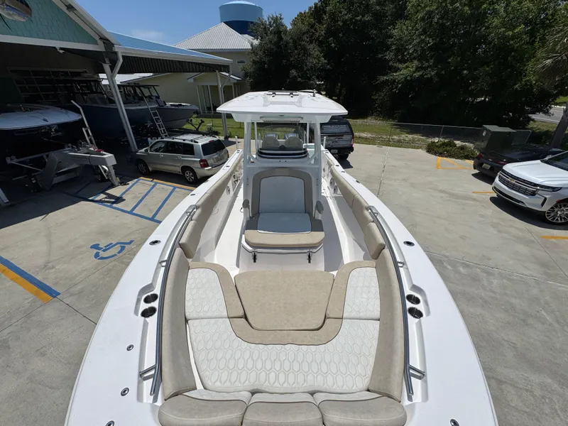 Slide: The Image of 2022 Sea Fox 288 Commander boat with spacious seating, parked outdoors. - 27
