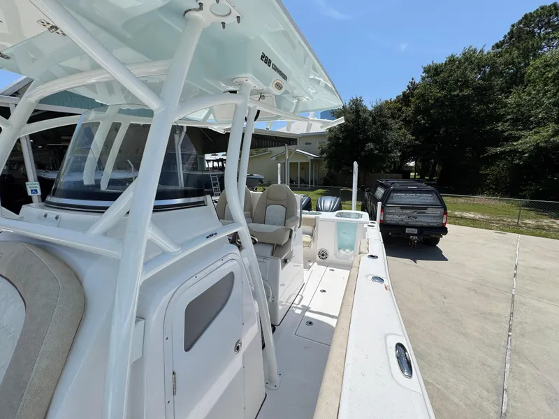 Slide: The Image of 2022 Sea Fox 288 Commander boat docked, showcasing sleek design and spacious deck. - 29