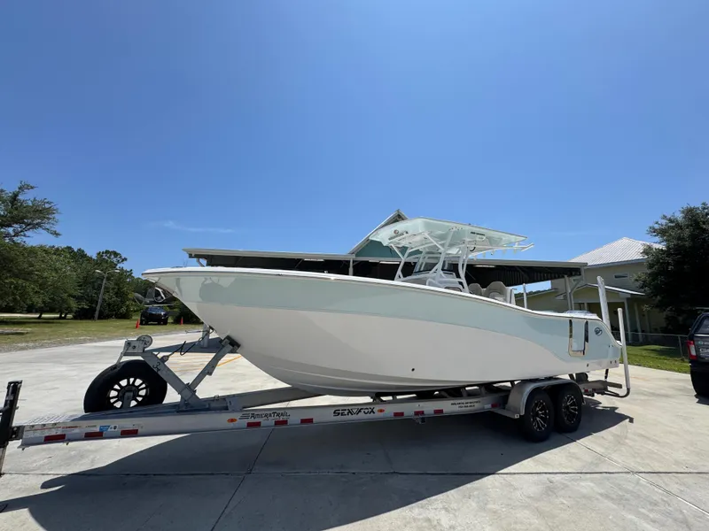 Slide: The Image of 2022 Sea Fox 288 Commander boat on trailer under clear blue sky. - 3