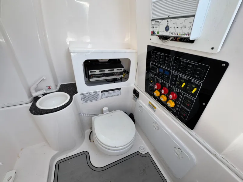 Slide: The Image of 2022 Sea Fox 288 Commander boat bathroom with toilet, sink, and control panel. - 32