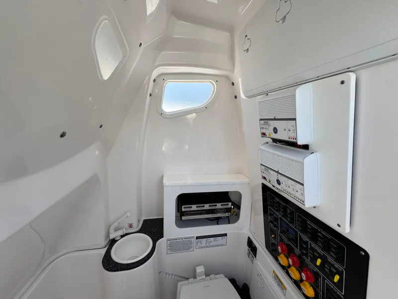Slide: The Image of Interior of 2022 Sea Fox 288 Commander boat, featuring control panels and compact amenities. - 33